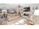 Open concept living room with modern fireplace, large TV and hardwood floors at 16800 Se 80Th Bathurst Ct, The Villages, FL 32162