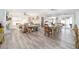 Spacious open living area featuring hard surface floors, a dining area, and ample natural light at 16800 Se 80Th Bathurst Ct, The Villages, FL 32162