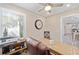 Office with a ceiling fan, a neutral carpet, natural light, and a desk at 16800 Se 80Th Bathurst Ct, The Villages, FL 32162
