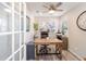 Home office with french doors, a neutral carpet, natural light, and a desk at 16800 Se 80Th Bathurst Ct, The Villages, FL 32162