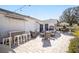 A backyard patio featuring an outdoor bar, outdoor seating, and elegant patio pavers at 16800 Se 80Th Bathurst Ct, The Villages, FL 32162