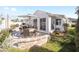 Well-furnished patio featuring a dining table with an umbrella and views of the home and lawn at 16800 Se 80Th Bathurst Ct, The Villages, FL 32162