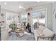 Bright sunroom with lots of natural light, a ceiling fan, and cozy seating areas at 16800 Se 80Th Bathurst Ct, The Villages, FL 32162