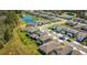 Aerial view of a residential neighborhood with ponds, mature trees, and sidewalks at 17291 Saw Palmetto Ave, Clermont, FL 34714