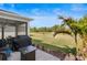 Large, beautifully landscaped backyard featuring a screened patio, grill, and green space at 17291 Saw Palmetto Ave, Clermont, FL 34714