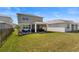Expansive backyard features a covered patio with dining and seating areas for entertaining at 17291 Saw Palmetto Ave, Clermont, FL 34714