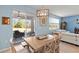 Bright dining room with a wooden table set and sliding glass door access to patio at 17291 Saw Palmetto Ave, Clermont, FL 34714
