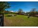 A fenced dog park features a lush green space, benches, and convenient waste disposal stations at 17291 Saw Palmetto Ave, Clermont, FL 34714