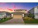 Charming two-story home featuring a brick driveway, neutral siding and a well-manicured lawn at 17291 Saw Palmetto Ave, Clermont, FL 34714