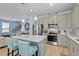 Spacious kitchen featuring stainless steel appliances, shaker cabinets, and a white countertop island at 17291 Saw Palmetto Ave, Clermont, FL 34714