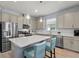 Bright kitchen features stainless steel appliances, shaker cabinets, and a white countertop island at 17291 Saw Palmetto Ave, Clermont, FL 34714