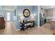 Cozy living room featuring hardwood floors, console table with lamps, and a stainless steel refrigerator at 17291 Saw Palmetto Ave, Clermont, FL 34714