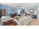 Spacious living room featuring hardwood floors, neutral colored couches, and a ceiling fan at 17291 Saw Palmetto Ave, Clermont, FL 34714