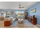 Open concept living room with hardwood floors, a ceiling fan, and a large rug at 17291 Saw Palmetto Ave, Clermont, FL 34714