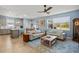 Open concept living room with hardwood floors, large window and light blue walls at 17291 Saw Palmetto Ave, Clermont, FL 34714
