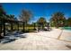A resort-style pool features pergolas and lounge chairs under a clear, sunny sky at 17291 Saw Palmetto Ave, Clermont, FL 34714