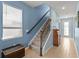 Staircase with carpeted steps, wood railing, and a window providing ample natural light at 17291 Saw Palmetto Ave, Clermont, FL 34714