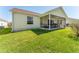 Spacious backyard featuring a screened lanai, lush lawn and an unobstructed view at 17416 Se 71St Currituck Ter, The Villages, FL 32162
