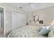 Inviting bedroom with a full closet and a mirrored dresser at 17416 Se 71St Currituck Ter, The Villages, FL 32162