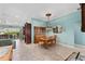 Traditional dining room with classic wood furniture, ornate chandelier, and light blue walls at 17416 Se 71St Currituck Ter, The Villages, FL 32162