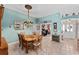Charming dining room featuring traditional wood furniture, decorative lighting, and tile flooring at 17416 Se 71St Currituck Ter, The Villages, FL 32162