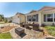 Inviting front patio featuring a comfortable seating area and a well-manicured lawn at 17416 Se 71St Currituck Ter, The Villages, FL 32162