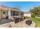 Inviting front patio with a comfortable seating area, perfect for outdoor relaxation and enjoying the neighborhood at 17416 Se 71St Currituck Ter, The Villages, FL 32162