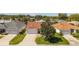 Charming single-story home featuring well-manicured lawn, mature tree, and two-car garage at 17416 Se 71St Currituck Ter, The Villages, FL 32162