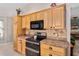 Wooden cabinets and stainless steel appliances fill this bright kitchen at 17416 Se 71St Currituck Ter, The Villages, FL 32162