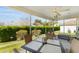 Relaxing screened lanai offering seating to enjoy a private and lush green outdoor view at 17416 Se 71St Currituck Ter, The Villages, FL 32162
