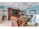 Cozy living room with comfortable seating, built-in entertainment center, and open layout at 17416 Se 71St Currituck Ter, The Villages, FL 32162