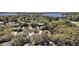 Expansive aerial shot showcasing the neighborhood's homes, lush greenery, and serene lake at 17421 Woodfair Dr, Clermont, FL 34711