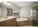 Bathroom featuring a corner soaking tub and a separate shower at 17421 Woodfair Dr, Clermont, FL 34711