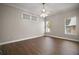 Bedroom featuring wood floors, ceiling fan, and large windows providing ample natural light at 17421 Woodfair Dr, Clermont, FL 34711