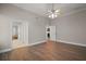 Bedroom features hardwood floors and a ceiling fan at 17421 Woodfair Dr, Clermont, FL 34711