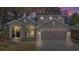 Charming home with a two-car garage, a well-maintained lawn and a palm tree at 17421 Woodfair Dr, Clermont, FL 34711