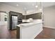 Bright kitchen featuring stainless steel appliances and a white breakfast bar at 17421 Woodfair Dr, Clermont, FL 34711