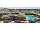 Community clubhouse with a sparkling pool and lush landscaping in a well-maintained neighborhood at 17421 Woodfair Dr, Clermont, FL 34711