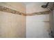 Shower stall with tile surround and a built-in shelf at 17421 Woodfair Dr, Clermont, FL 34711