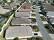 Aerial view of home showcasing the roof, driveway, and manicured landscaping at 1805 Endsley Ct, The Villages, FL 32162