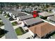 Aerial view of home highlighting the roof, driveway, and landscaping at 1805 Endsley Ct, The Villages, FL 32162