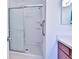 Bathroom featuring a walk-in shower stall, safety bar, and vanity with mirror at 1805 Endsley Ct, The Villages, FL 32162