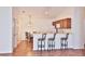 Cozy dining area with barstool seating and a lovely chandelier that is open to the kitchen at 1805 Endsley Ct, The Villages, FL 32162