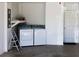 Laundry room with washer, dryer, shelving, and access to exterior at 1805 Endsley Ct, The Villages, FL 32162