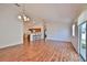 Spacious living room with laminate floors and a dining area that is open to the kitchen at 1805 Endsley Ct, The Villages, FL 32162