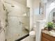 Bathroom featuring a tiled shower with a glass door, bench, and grab bar, plus a toilet and vanity at 1970 Farmington Ct, Clermont, FL 34711