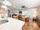 Dining room with white countertops and view to the main dining table and chairs and a large flatscreen TV at 1970 Farmington Ct, Clermont, FL 34711