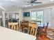 Dining room with large table and chairs with a view to the living room and a flatscreen TV at 1970 Farmington Ct, Clermont, FL 34711