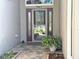 Inviting front entrance showcasing decorative glass door, sidelights, and brick paver walkway at 1970 Farmington Ct, Clermont, FL 34711