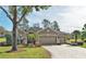 Charming single-story home with a brick driveway, three-car garage, and beautifully landscaped front yard at 1970 Farmington Ct, Clermont, FL 34711